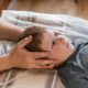 Osteopath performing gentle cranial osteopathy treatment on a patient at The Body Project in Chatswood.