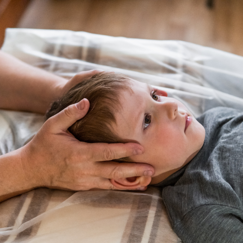 Osteopath performing gentle cranial osteopathy treatment on a patient at The Body Project in Chatswood.